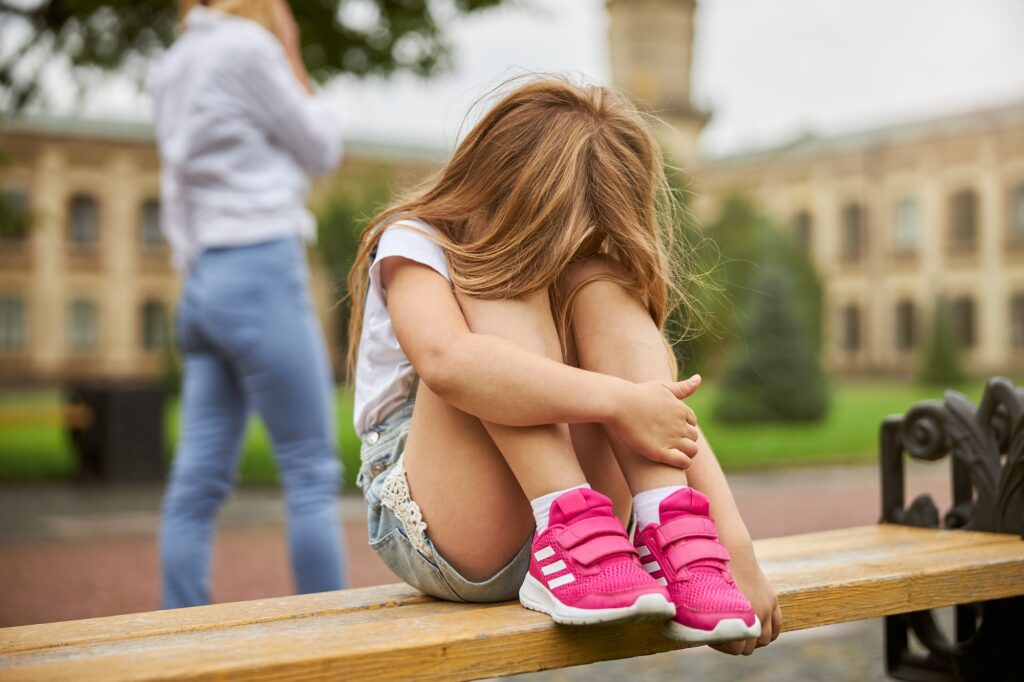 Little female child spending time the bench